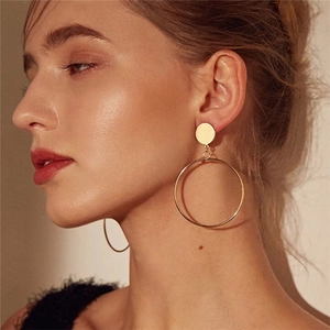 Minimalist gold hoop earrings featuring a small stud and large thin circular drop for women