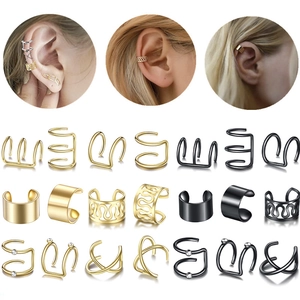 Set of minimalist gold and black non-piercing ear cuffs with various textured designs