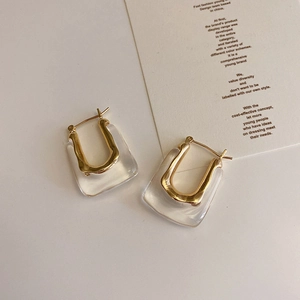 Modern U-shaped acrylic and gold metal earrings in a minimalist geometric style