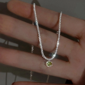 Sparkling silver necklace featuring a brilliant green gemstone pendant for women
