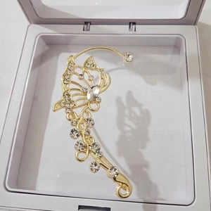 Elegant gold butterfly ear cuff with sparkling zircons displayed in a clear 3D gift box