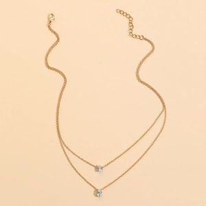 Détail du collier double rang doré avec pendentifs en zircon et fermoir mousqueton réglable