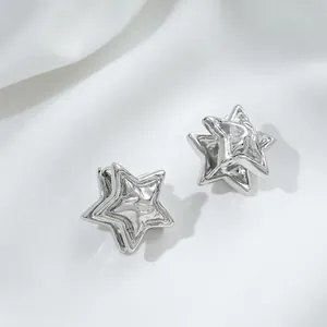 Detail of silver star-shaped hoop earrings with textured 3D water ripple surface