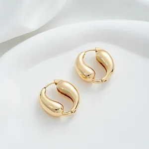 Detailed close-up of 14K gold plated teardrop hoop earrings with high polish finish