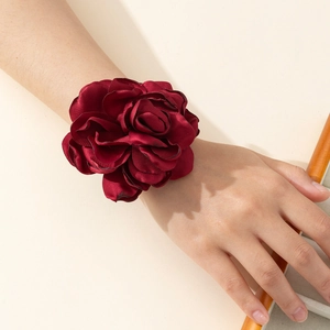Detailed view of an elegant large burgundy satin rose wrist corsage with layered petals