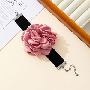 Detail of pink satin fabric rose choker necklace with soft black velvet strap and clasp
