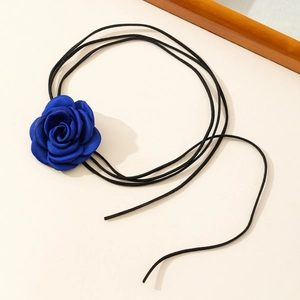 Detailed view of the handcrafted deep blue satin rose on a thin black velvet choker string
