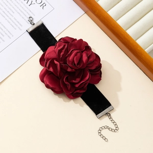 Detail of dark red velvet rose choker with elegant fabric petals and silver metal clasp