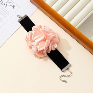 Detail of pink satin flower choker with black velvet strap and silver lobster clasp