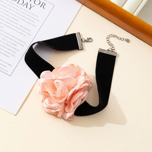 Close-up of black velvet choker with a large pink fabric rose and adjustable chain