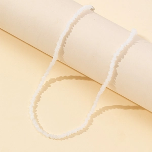 Minimalist white irregular beaded necklace with metallic lobster clasp on display