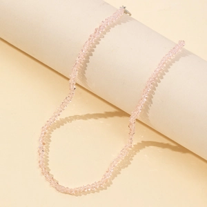 Macro view of light pink faceted glass beaded necklace with fine silver metal clasp