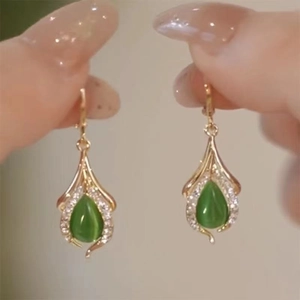 Elegant gold drop earrings with green cat-eye stone and white zircon accents