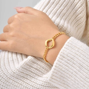 Women's gold stainless steel curb chain bracelet with geometric hollow centerpiece