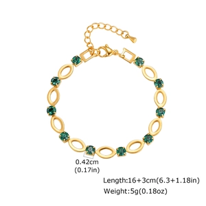 Macro detail of gold plated stainless steel chain with green crystal and size markings