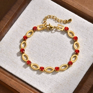 Detailed macro view of gold plated hollow oval links and red rhinestones on a lady bracelet