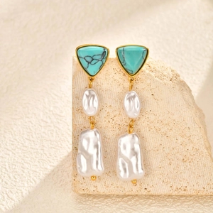 Gold stainless steel earrings with triangle turquoise and baroque pearls on stone display