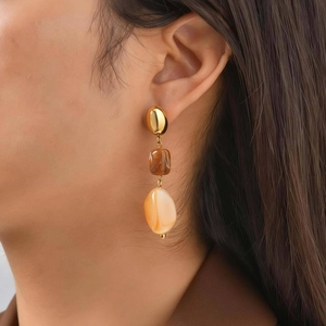 Maillard style gold stainless steel drop earrings with brown resin beads on model