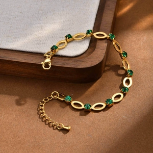 Detail of gold-plated stainless steel bracelet with green stones and lobster clasp closure