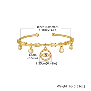 Detailed view of gold evil eye cuff bracelet with 5.4cm inner diameter measurement