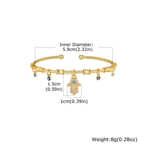 Detailed view of gold copper Hamsa bangle with evil eye charms and 5.9cm diameter size info