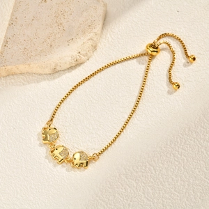 Macro detail of gold elephant bracelet with zircon stones and adjustable slider box chain