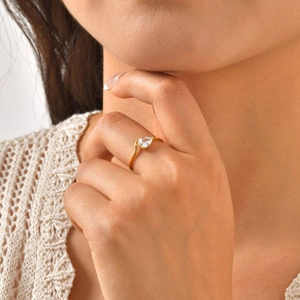 Close-up detail of a gold-plated stainless steel ring with a pear-shaped white zircon