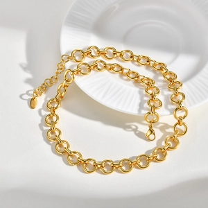 Detail of gold-plated stainless steel link chain with K18 engraving on the oval tag