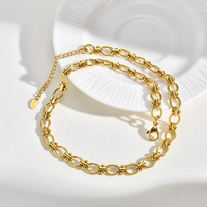 Detail of gold chain necklace with round beads, lobster clasp and K18 hallmark tag