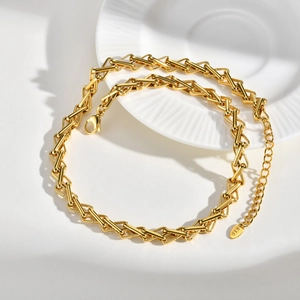 Close-up of gold stainless steel link chain with K18 tag and secure lobster clasp