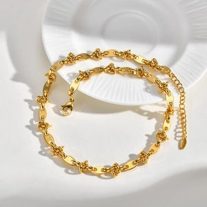 Detail of gold chunky link chain necklace with K18 engraved tag and lobster clasp