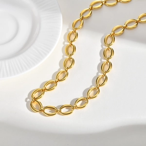 Close-up of golden stainless steel chain featuring polished oval link texture