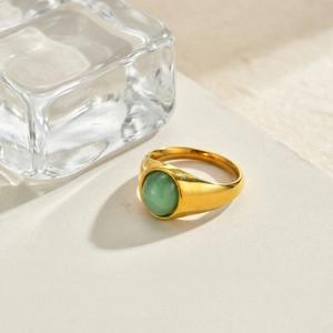 Detailed shot of a vintage gold wide ring featuring a green aventurine stone centerpiece