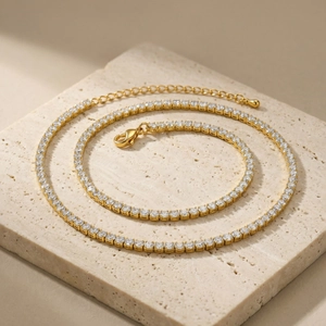 Detailansicht der goldenen Tennis-Halskette mit Zirkonia auf einer Steinoberfläche