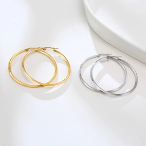 Flat polished hoop earrings in gold and silver finish with minimalist geometric design