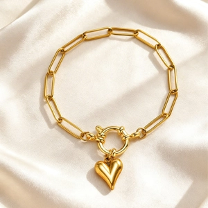 Gold stainless steel paperclip chain bracelet with a 3D heart pendant on silk
