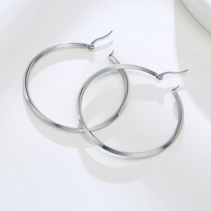 Detailed top view of large silver hoop earrings with a sleek flat geometric surface