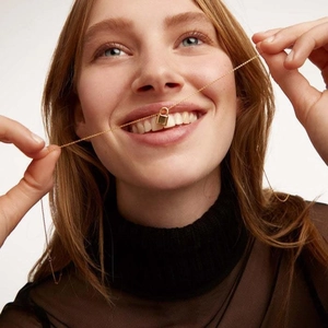 Minimalist gold titanium steel padlock necklace with fine chain shown on a model
