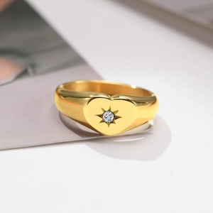Polished gold heart signet ring with a starburst set cubic zirconia for women
