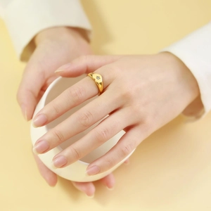 Elegant gold titanium steel signet ring with starburst zircon on woman's finger