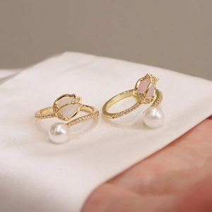 Elegant gold tulip rings with cat eye stone, pearls and crystals in a macro shot