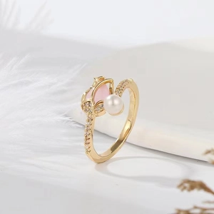 Detail of tulip ring featuring a pink stone, white pearl, and gold plated accents