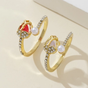 Close-up of golden tulip open rings with marquise stones, crystals and white pearls