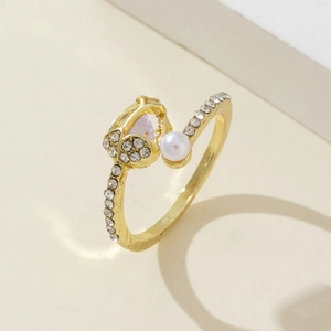Detail of tulip ring with opal petals, pearls, and crystals on a golden open band