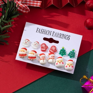Detailed view of Christmas earring set with Santa Claus and tree patterns on display card