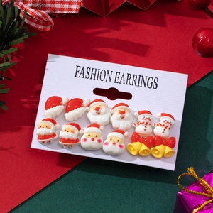 Detailed view of festive Christmas earring set with Santa and snowman patterns