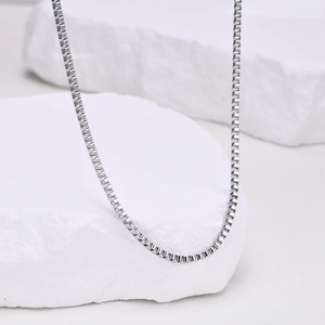 Gros plan d'un collier chaîne box argenté de 2mm avec finition polie et brillante