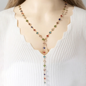 French style gold Y-necklace with multi-colored heart-shaped crystals on a female model