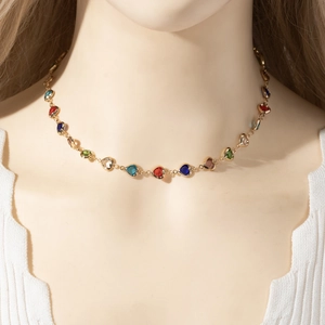 Chic gold Y-chain necklace featuring colorful heart-shaped crystals on model