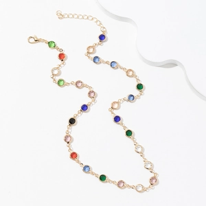 Detailed view of the gold lobster clasp and adjustable chain on a colorful gem necklace